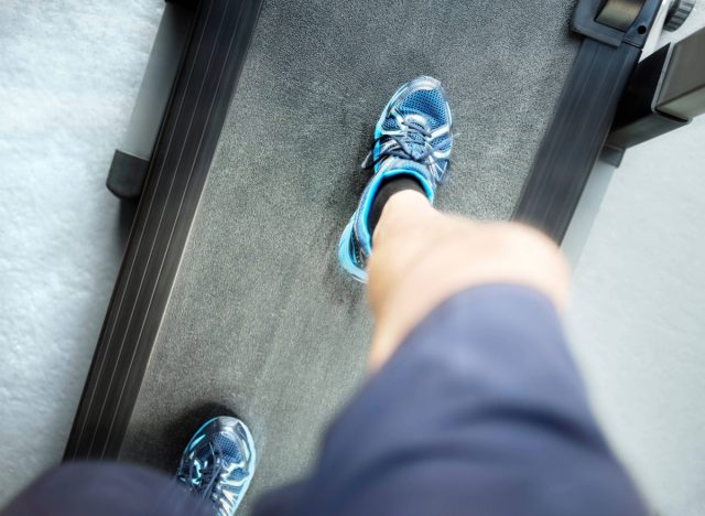 a low angle view of a person looking down while stepping