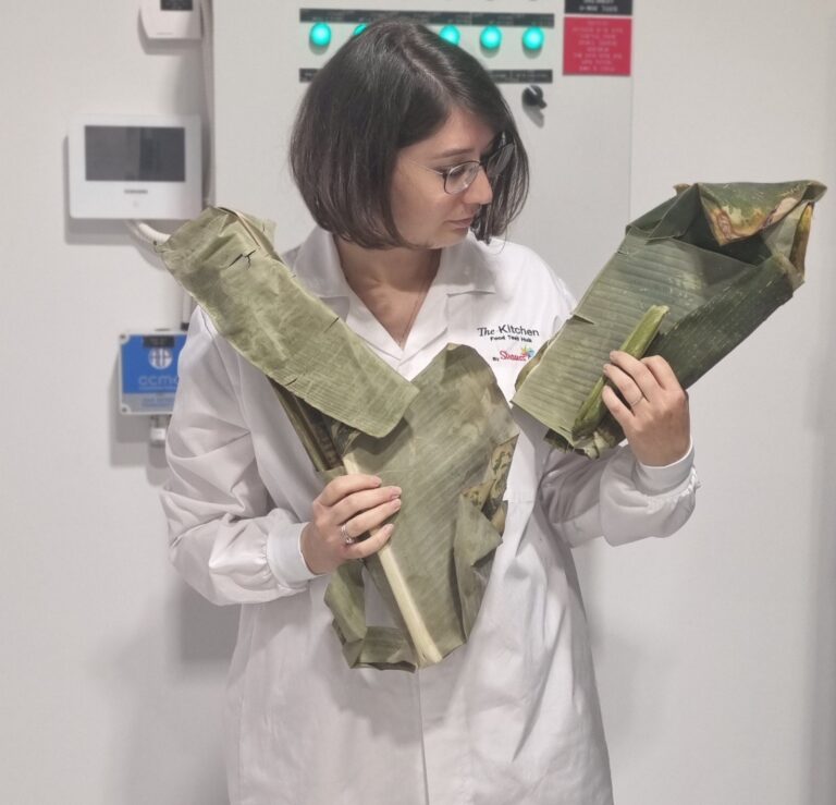 Dr. Michal Mayer holding banana leaves. Photo by Yulia Karra